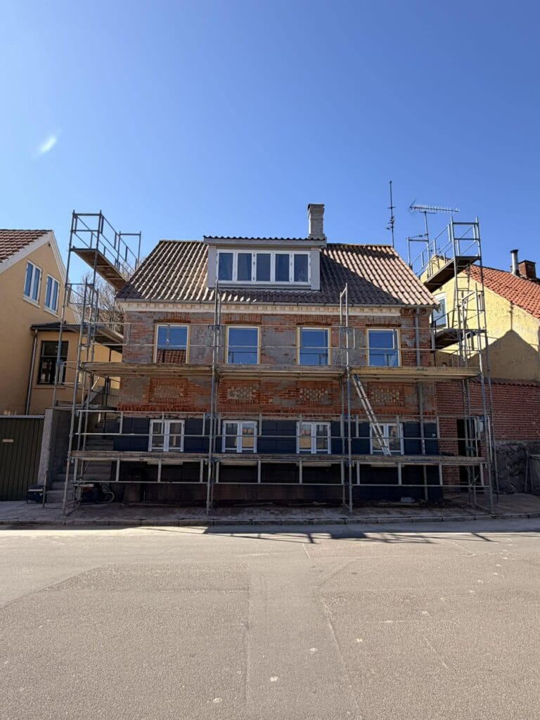 Vandskuring 5 Murstensfacade under stillads med nye vinduer hos NP Murermester