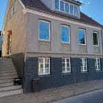 Sokkelpuds i Fredericia: byhus med lys netpuds og mørk sokkel